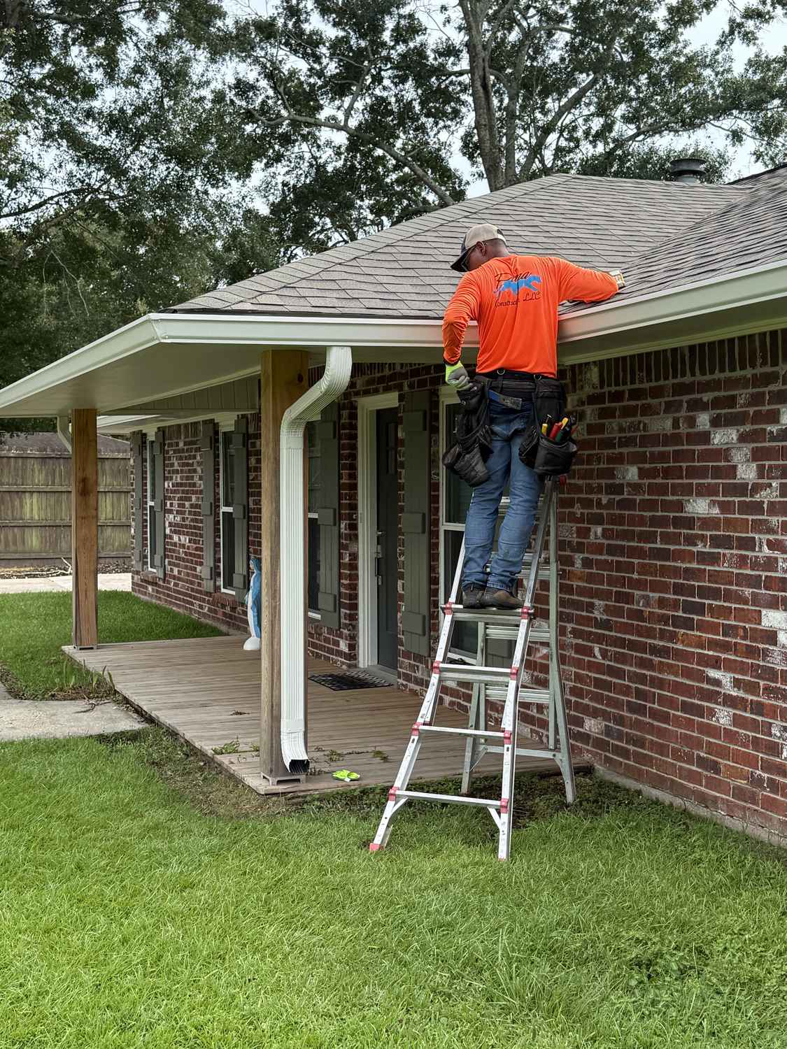 Exterior Pros installer on a ladder doing gutter work in Louisiana