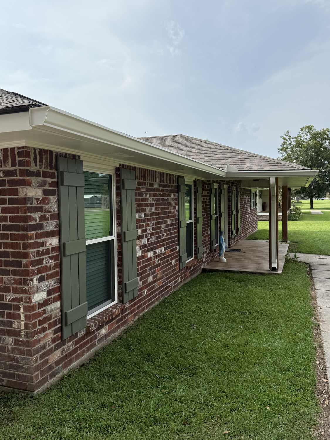 Finished gutter installation with downspout at a carport in Louisiana