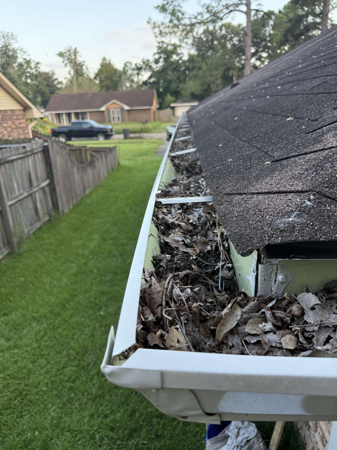 Gutter packed full of leaves needing cleaning at a home in Louisiana