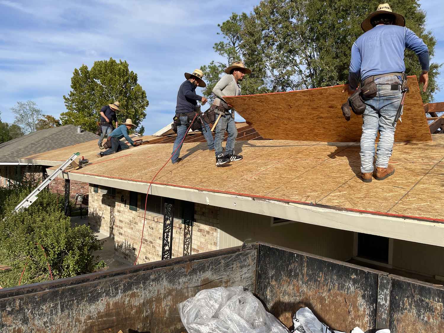 Exterior Pros roofing crew installing new decking on a Louisiana home
