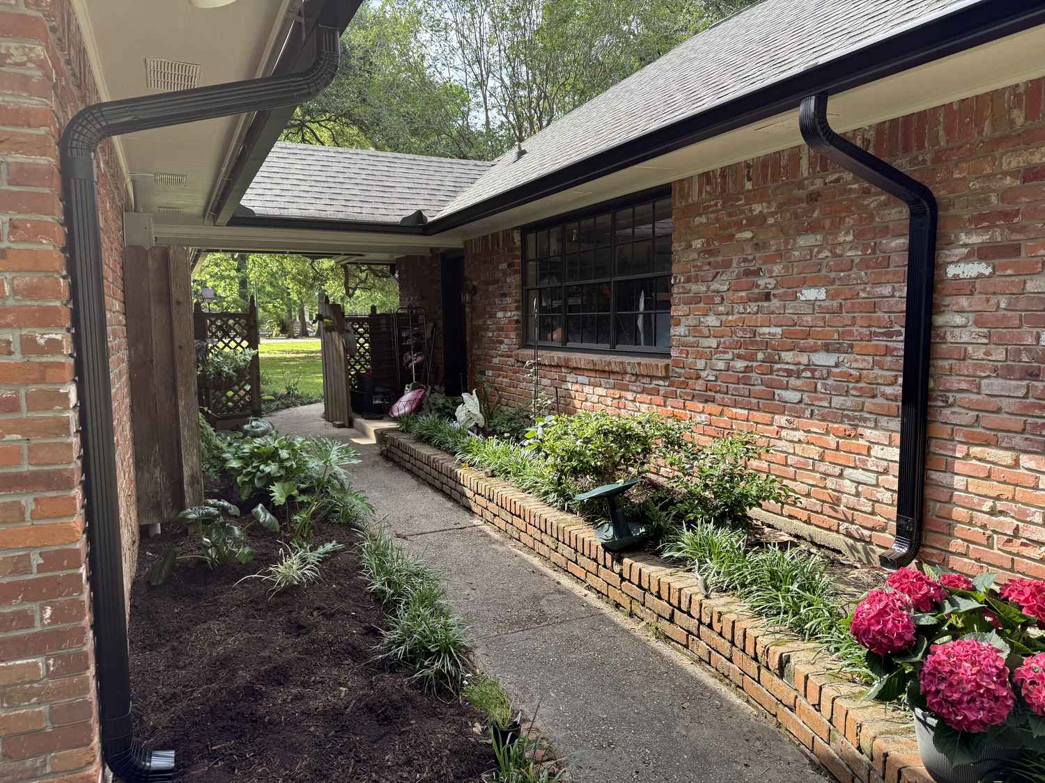 Seamless gutter installation on a red brick home in Ascension Parish, Louisiana
